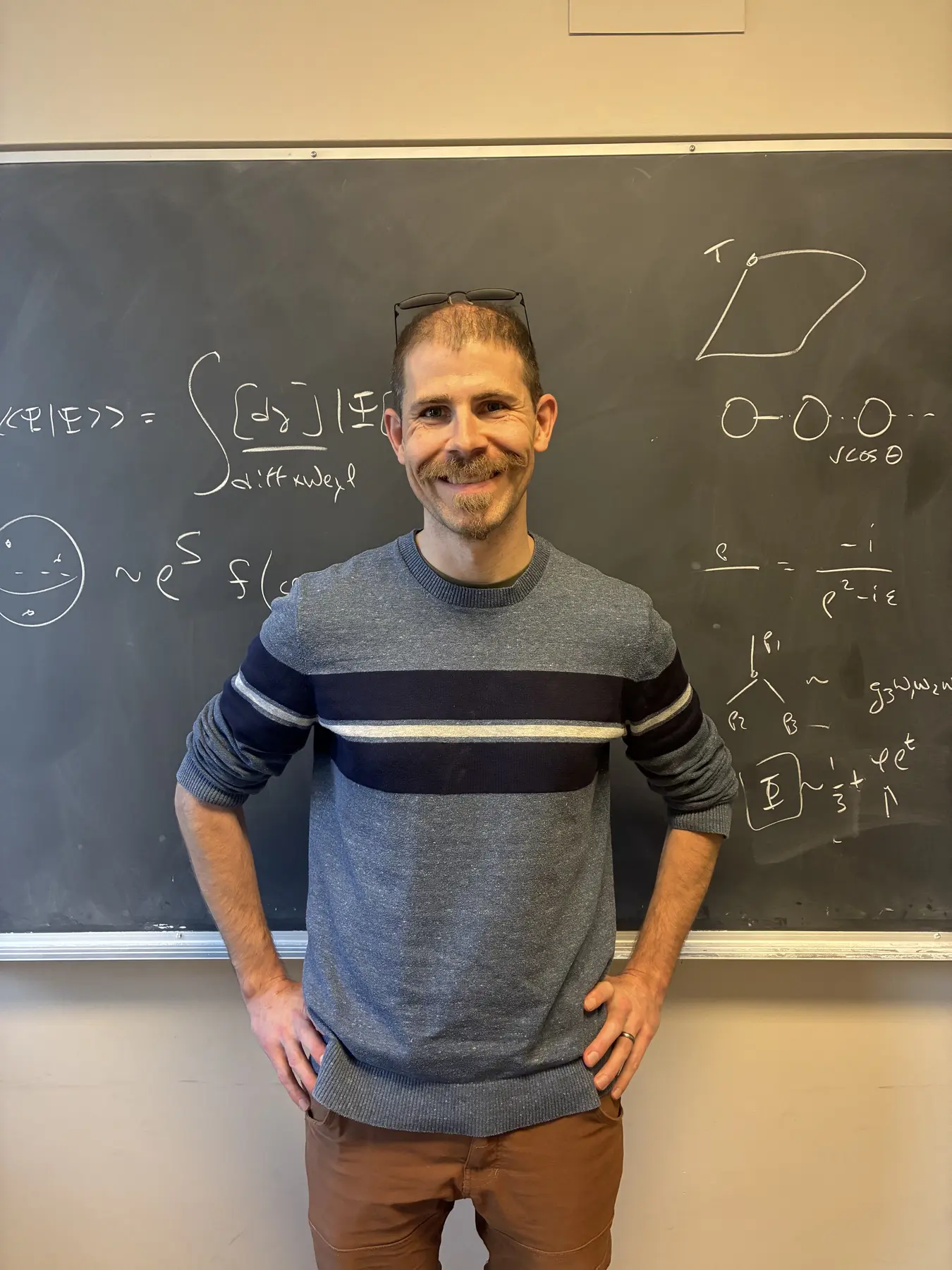 Kristan Jensen standing in front of a chalkboard