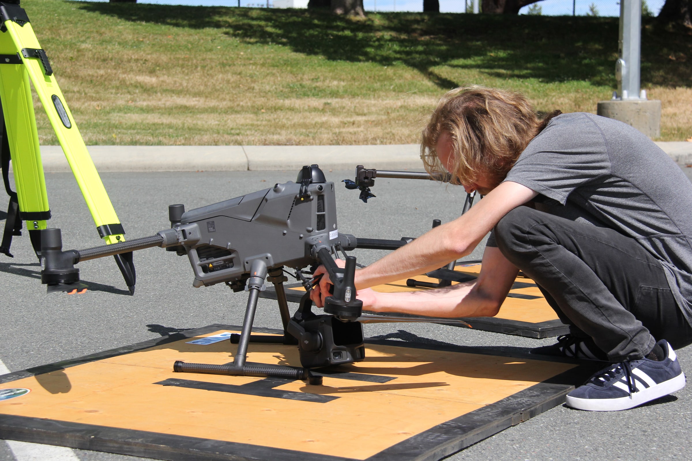 Researcher preparing a large industrial drone for an ACIS field test.