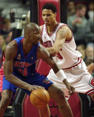 Detroit Pistons' Clifford Robinson, Left, Moves Around...